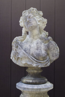 English cast limestone bust of a Bacchante atop a column.