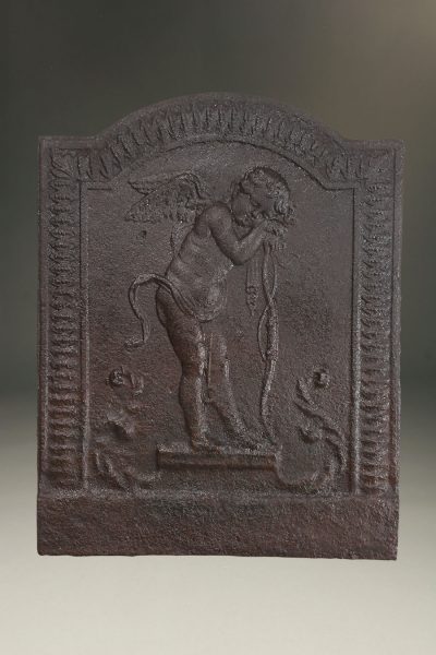 Late 18th century French fireback adorned with a sleepy winged cupid, circa 1770.