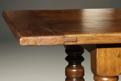 Custom English oak farmhouse table with hand hewn top and turned legs.