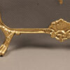 Solid brass folding fireplace screen with ornate castings.