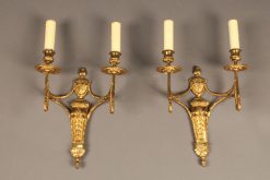 Pair of two arm French Louis XVI style bronze sconces.