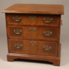 Small Chippendale style mahogany chest of drawers with brass handles on  sides