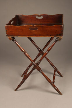 Antique butler's table with handled mahogany top tray and folding base.