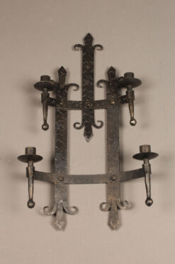 Wrought iron sconce with flure-di-lis design.