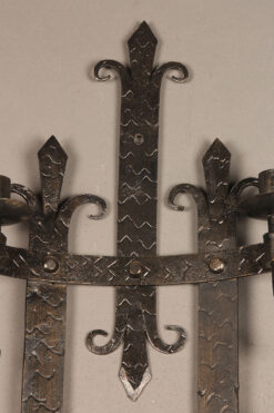 Alternative view of Wrought iron sconce with flure-di-lis design.