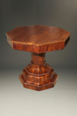 Octagonal center table with flame grained mahogany.